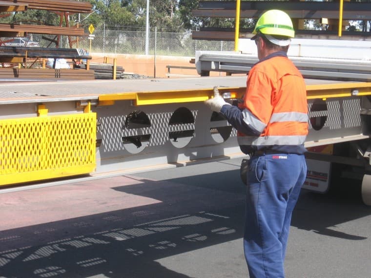 Smart move … a OneSteel worker folds out the walkway on the new Freighter extendable semi-trailer