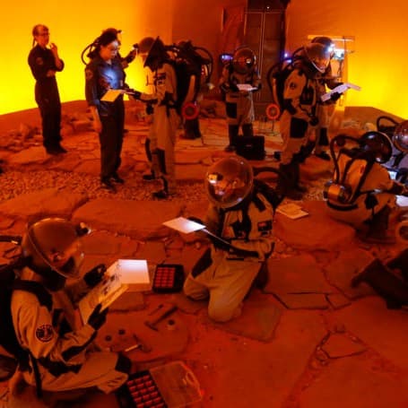 Students explore the Mars simulation, overseen by staff.