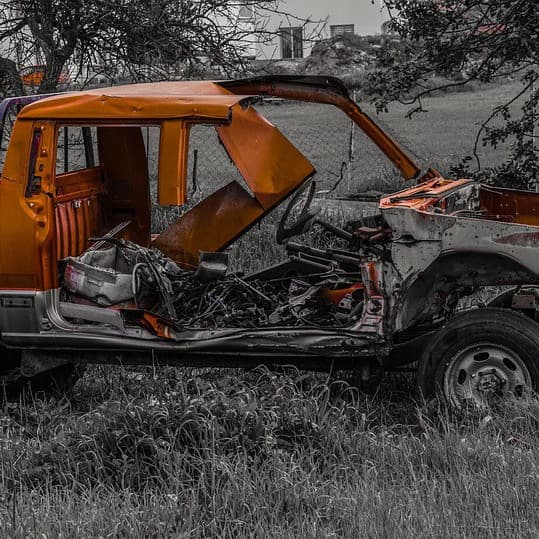 A wrecked car sits in a feild, providing an apt metaphor for Australia's local auto manufacturing.