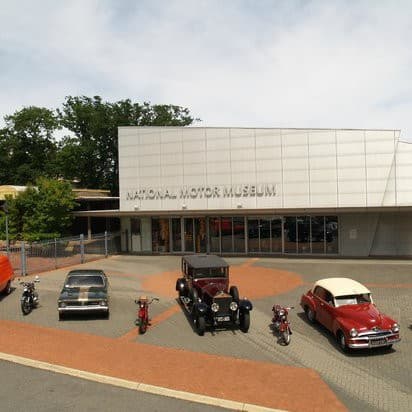 the australian motor museum, with vintage cars parked outside